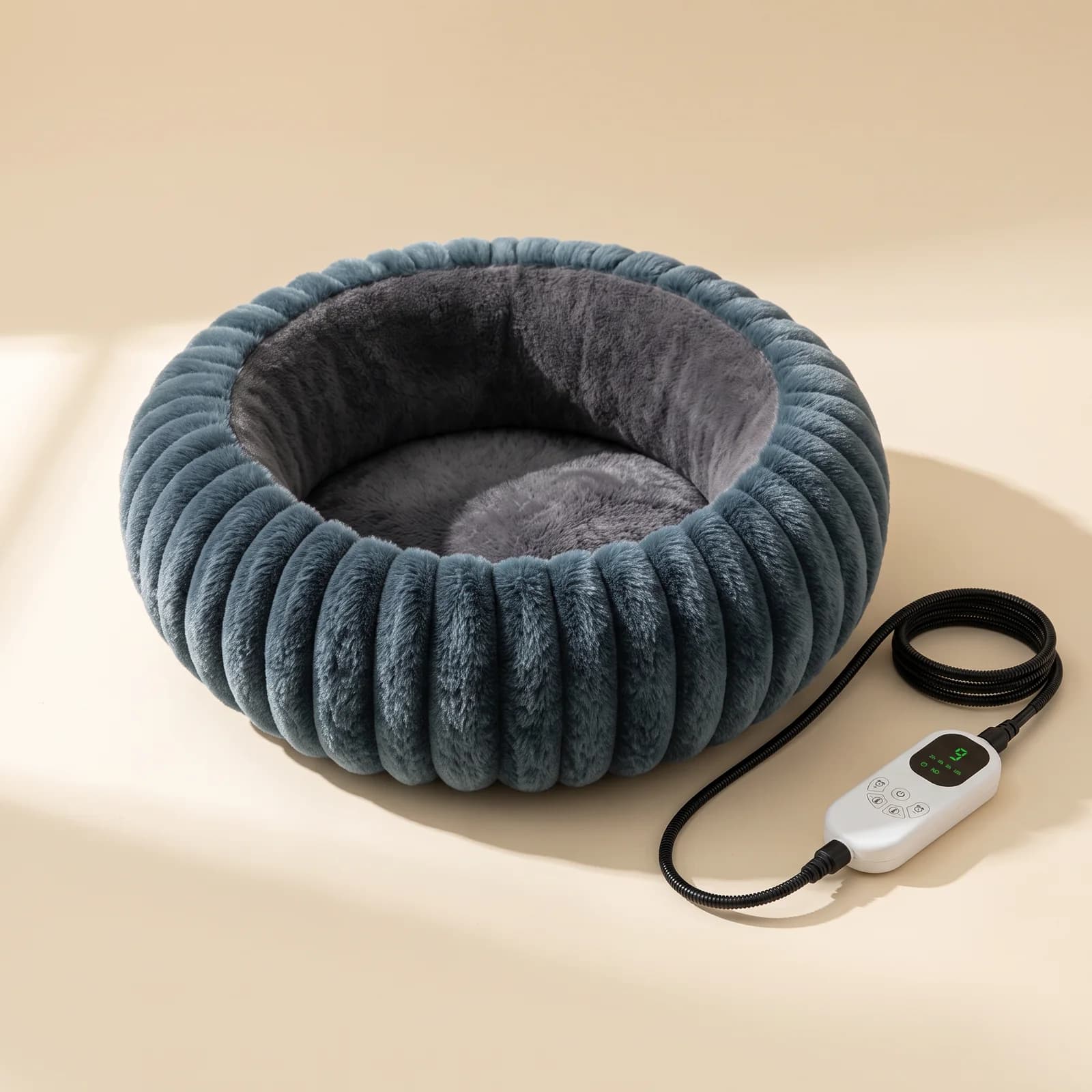 Teal heated donut bed with its controller on a cream background